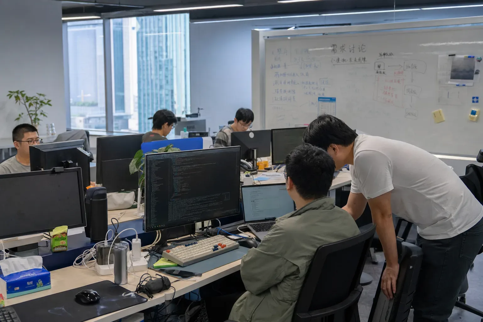 红数科技项目成员在办公区沟通需求与开发细节